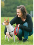 Woman with small dog looking off camera